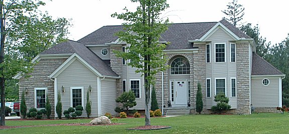 1st floor master bedroom with 9 ft. trayed ceiling. Optional master bedroom fireplace. Cathedral ceiling in great room with optional skylights. 2 story foyer. Formal dining room/parlor with trayed ceiling. 1st floor sun room/den. Partial stone or brick front. Arched covered porch. 1st floor laundry. 2-car side entry garage.