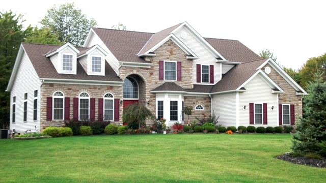 Large great room. Master bed and bath all with cathedral ceilings. 2-story foyer and hearth room. Double-sided fireplace. Vaulted 1st floor parlor/den with French doors and transom. Tray ceiling in bayed formal dining room. Large dinette/kitchen with desk. Optional skylights.   Large covered rear porch. 1st floor laundry. 3-car side entry garage.